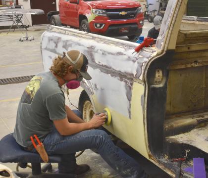 Auto Collision Technology student sanding a car.