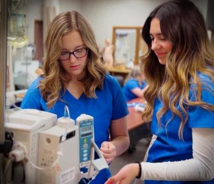Nursing students working with monitor.
